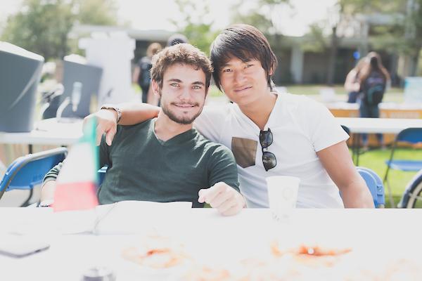 International student sitting with UNC ambassador at an event.